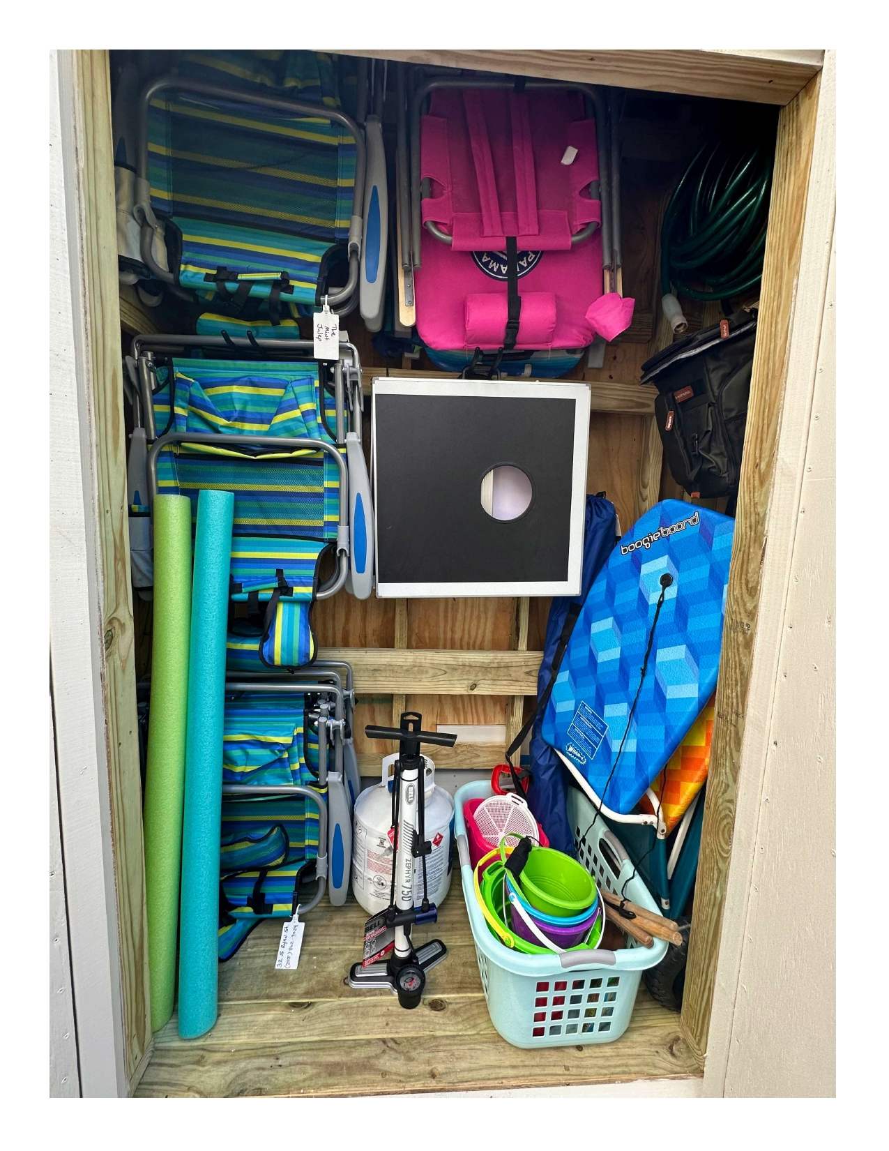 Beach Shed: Backpack Beach Chairs, Umbrella, Cooler, Beach Cart, Boogie Boards, Noodles, and a Corn Hole set for Backyard Fun